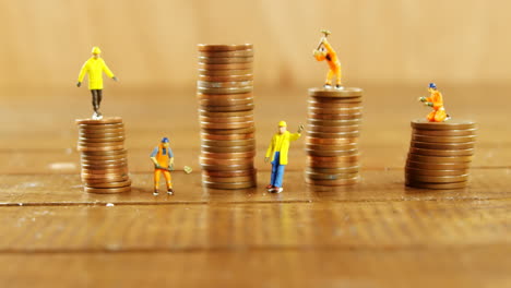 close-up of figurine with stack of coins