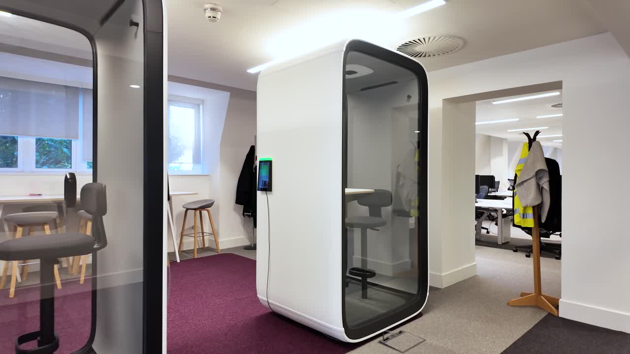 Soundproof office pods creating private and quiet working spaces in modern office environment