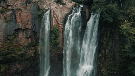 aerial drone backwards rising view over nauyaca waterfalls in costa rica