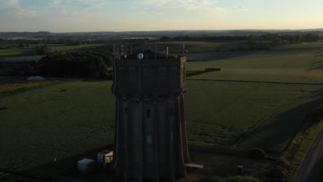 Aerial-footage-of-a-water-tower-on-a-summers-evening