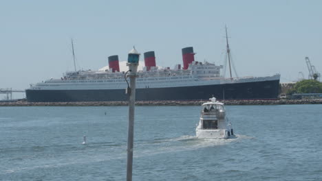 small boat in front of large ship