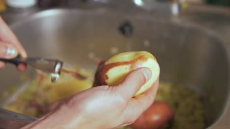 a man peeling a rooster potato