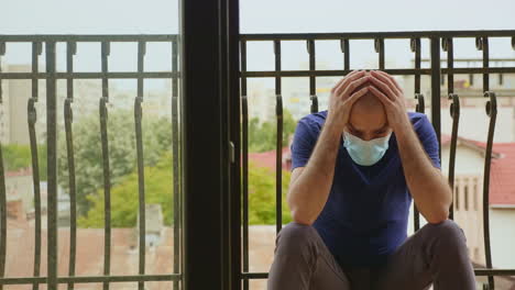 pensive man with disposable mask