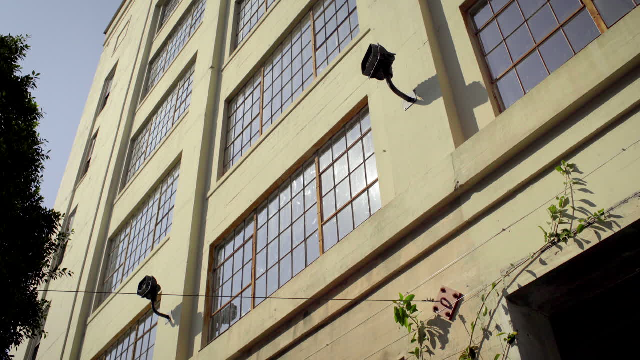 Low Angle View of a Building with Numerous Windows and Sun Reflections