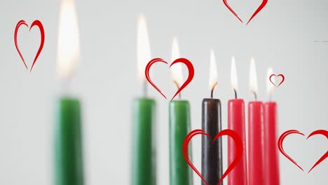 Animation-of-red-hearts-over-kwanzaa-candles-on-grey-background