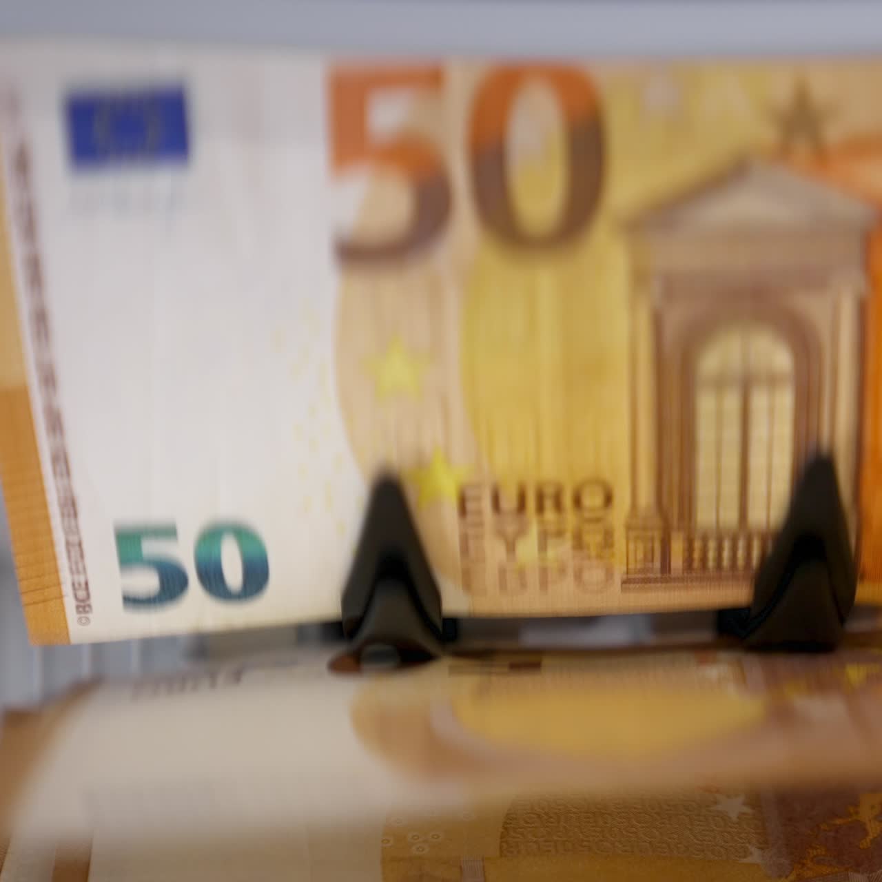 Work of counter machine. Currency counting equipment. Electronic banknote counter counting euro bills. Finance business concept. Close-up