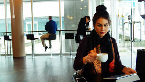 female executive working while having coffee