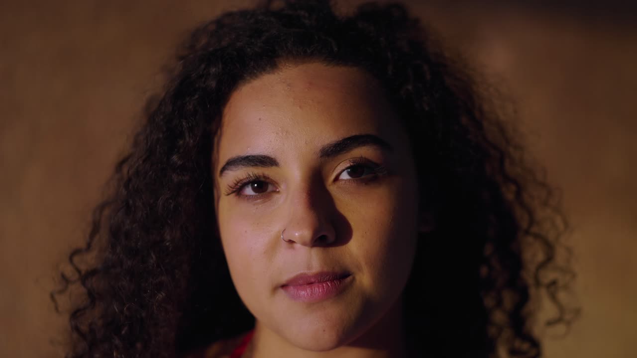 Close-up Portrait of a Young Woman with Curly Hair Showing Different Expressions
