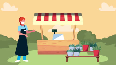 woman selling plants at an outdoor market stall during a pandemic