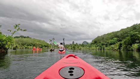 kayakers navigate scenic canal in krabi, thailand