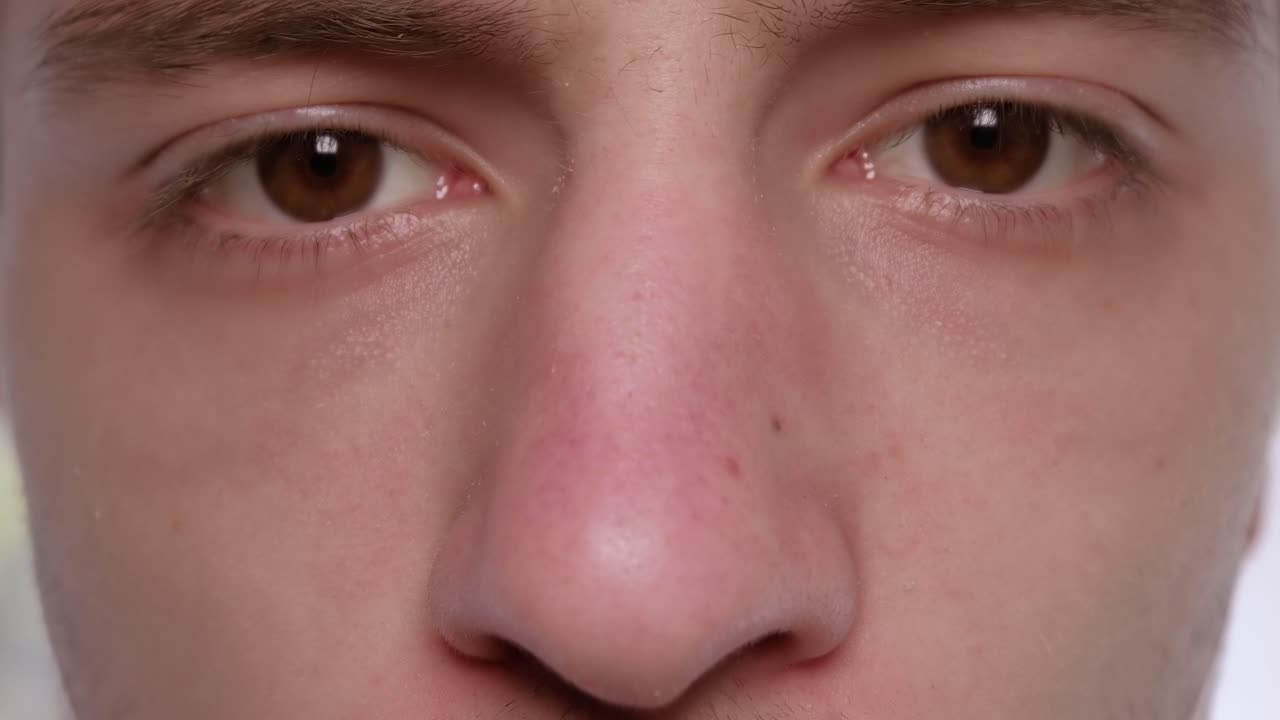 Caucasian man wearing an protective medical mask while looking at the camera. Close up. Quarantine and Corona Virus idea