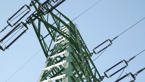 High-voltage-pylon-and-power-lines---low-angle-dolly-shot,-closeup