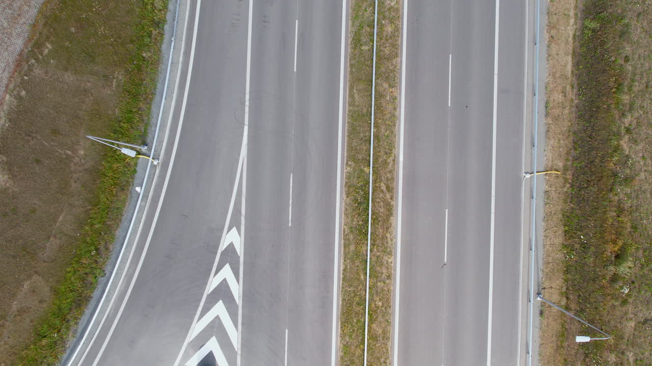 toma aérea de arriba hacia abajo de una carretera vacía a la luz del sol durante la pandemia de covid-19
