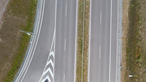 aerial top down shot of empty road in sunlight during covid-19 pandemic