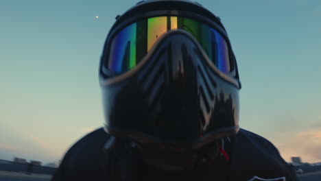 person in helmet riding on a bridge at dusk