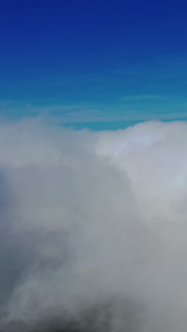 scenic view of beautiful sky. flying among soft white clouds moving on blue sky. high in blue sky through the fluffy clouds. vertical video