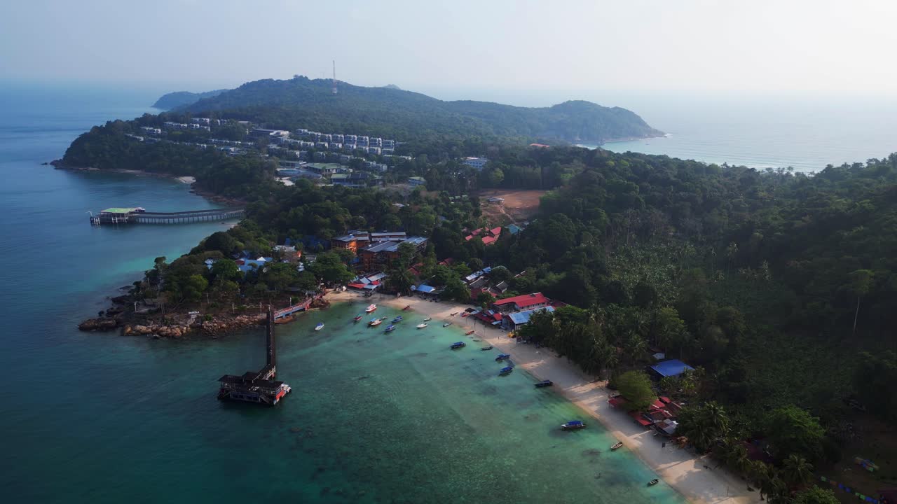 Morning mood Stunning aerial view speed ramp flight of a tropical island with a long wooden pier leading to a floating restaurant, surrounded by turquoise waters and lush green rainforest