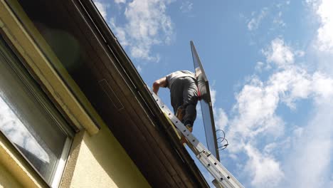 pv professional techincian climbing lather to install high-end solar panel