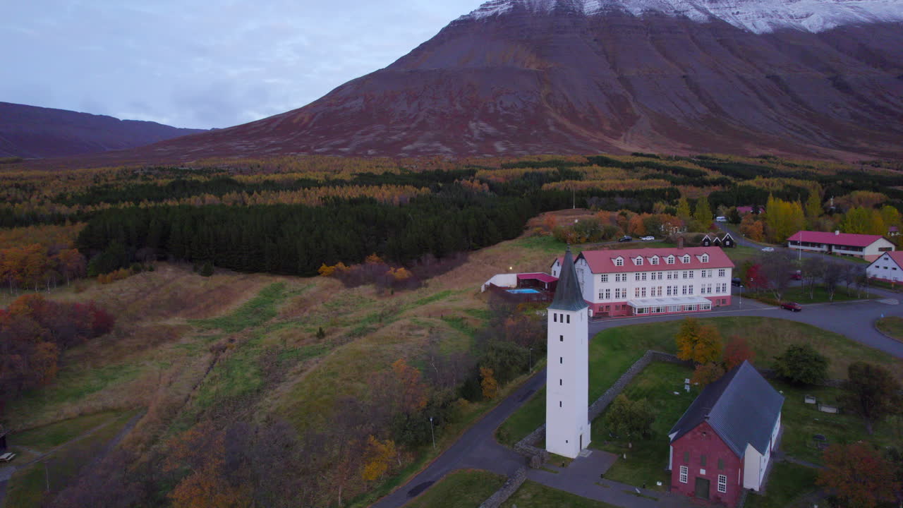 H&oacute;lar church and village in mountainous autumnal valley of north Iceland