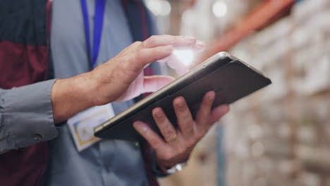 man using tablet in a warehouse