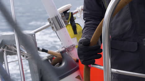 Hand-steering-a-yacht-while-sailing-in-the-Arctic