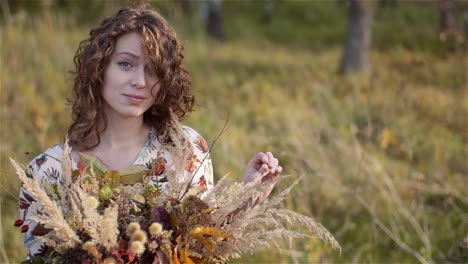 Plano-Medio-De-Una-Mujer-Mirando-El-Ramo-De-Flores-Silvestres-En-El-Verano-2