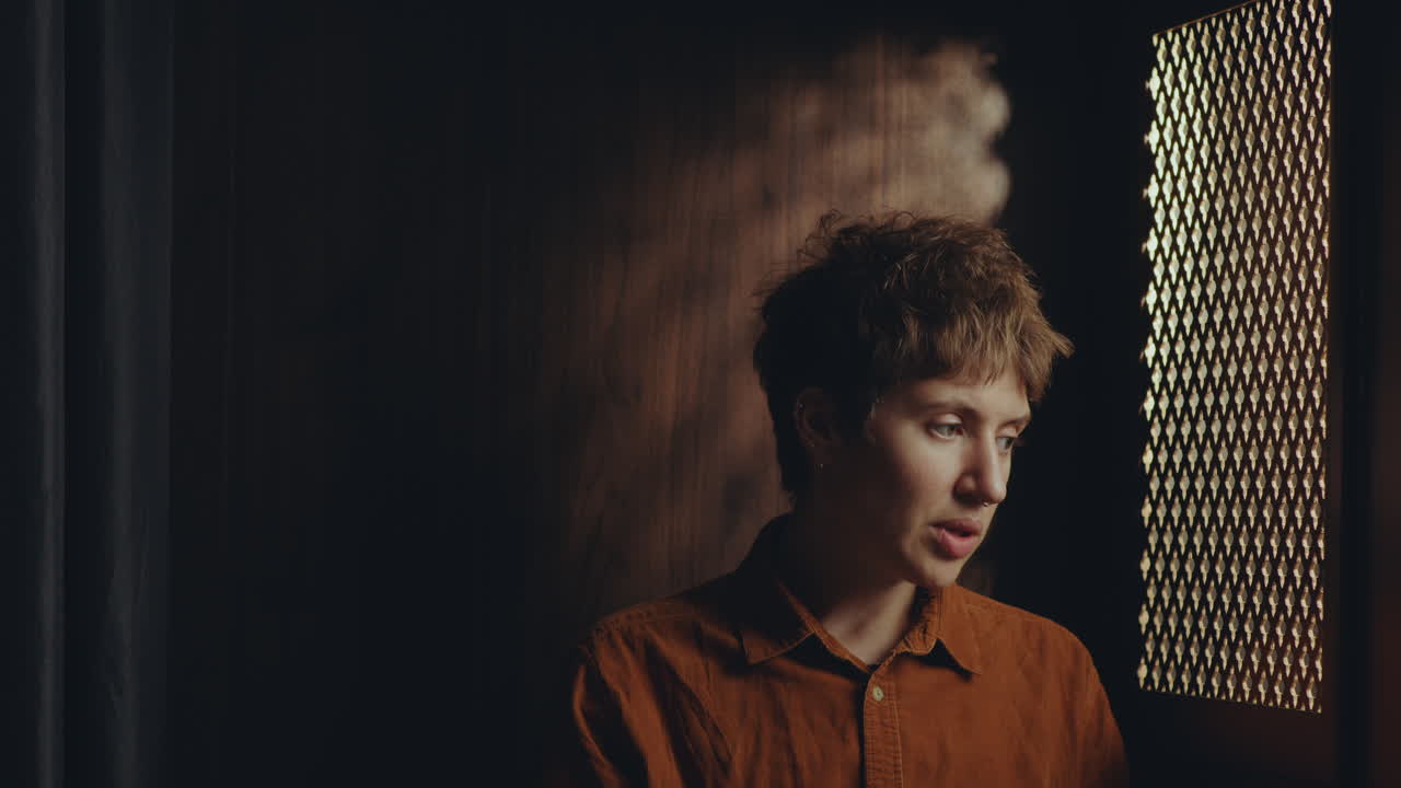 Young Regretful Woman Having Private Talk with Priest in Confession Booth