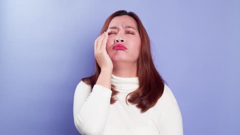 Frustrated-stressed-young-Asian-woman-coping-emotions-disappointed-isolated-over-a-violet-background