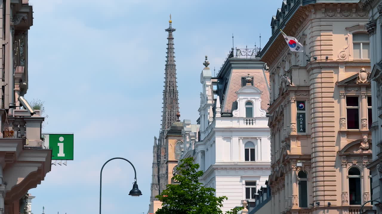 Vienna, Austria - June 9, 2025: Historical buildings of modern Vienna, Austria. Steeple of the stunning Saint Stephen's Cathedral at backdrop
