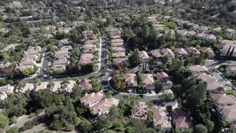 aerial view overlooking calabasas city neighborhood luxury homes on a sunny day in california, panning shot