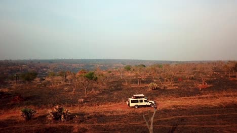 a white tourist vehicle jeep offroad driving in african safari