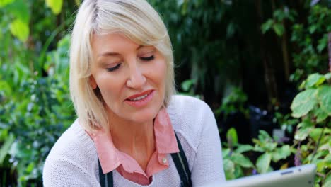 mature woman using digital tablet