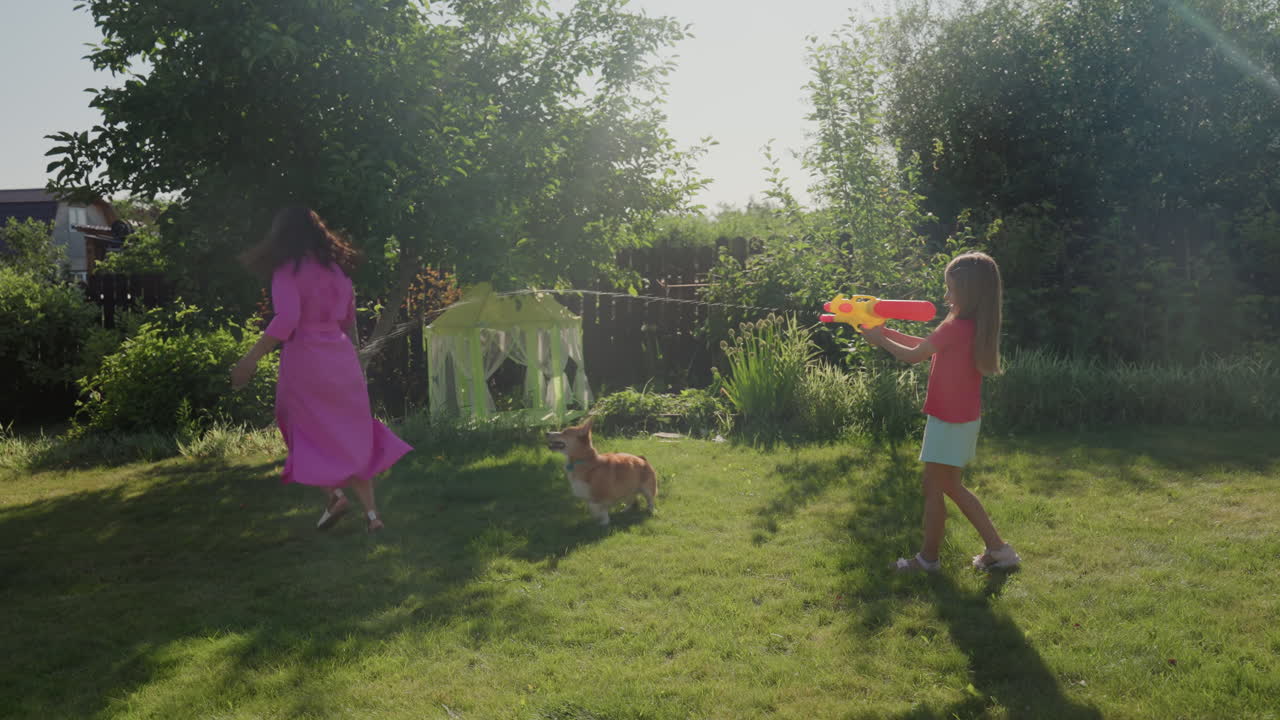 Joyful Outdoor Splash, Children Play With Colorful Water Toys, Sunlit Garden Filled With Laughter And Playful Splashes, Summer Fun Involves Children Fighting With Water Across Bright Lawn