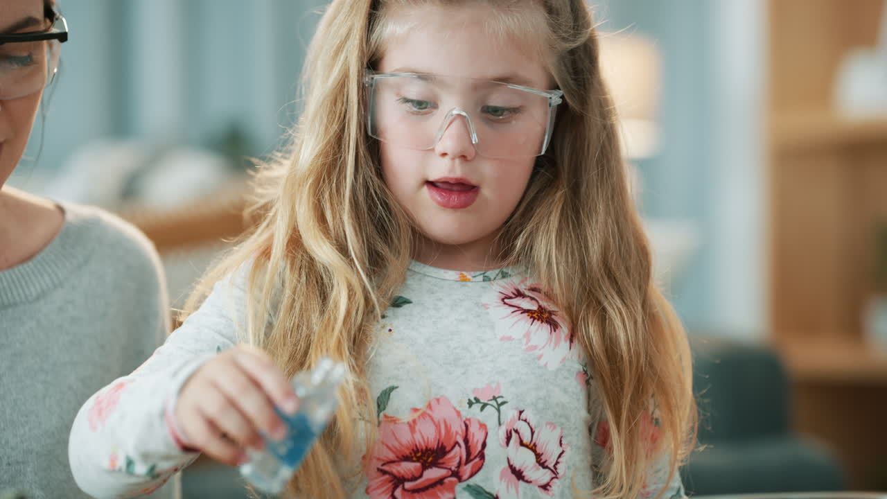 niño haciendo un experimento científico con el padre