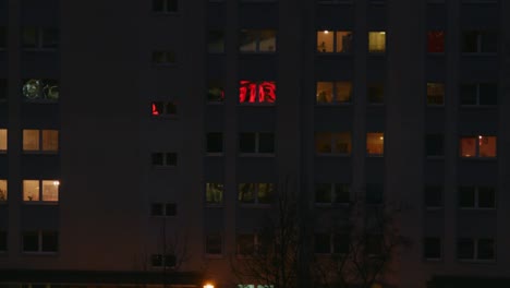 reflection in windows of concrete building at night in berlin, germany