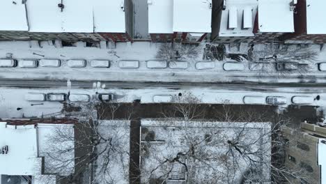 Snow-covered-cars,-houses-and-buildings-in-american-street-of-Town-in-USA