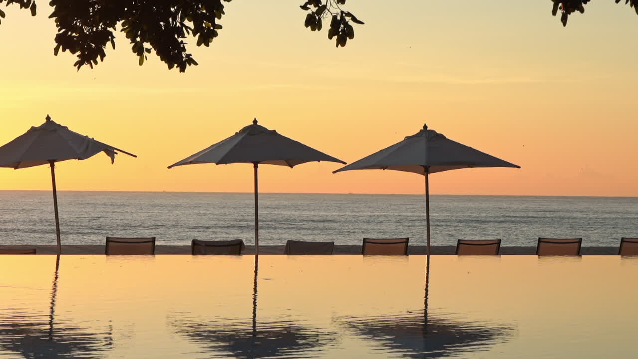 Soothing exotic sunset at luxury resort pool at golden hour