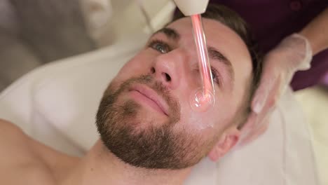 man receiving facial treatment