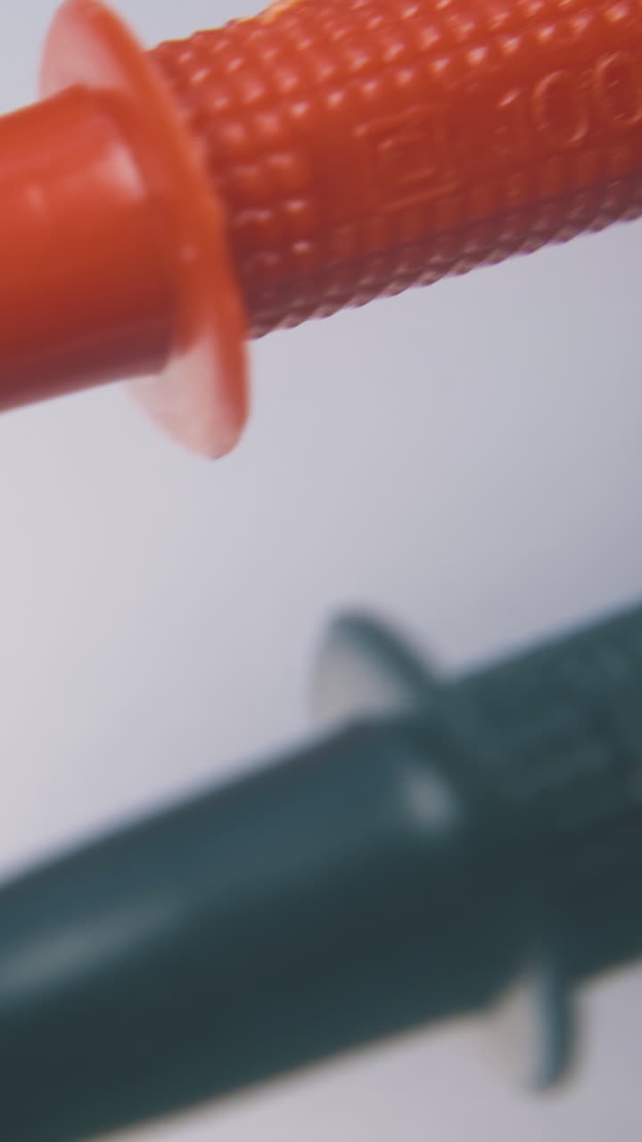 modern multimeter with color probes and scale lies on clean white background extreme close view