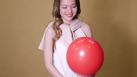 woman holding a red balloon