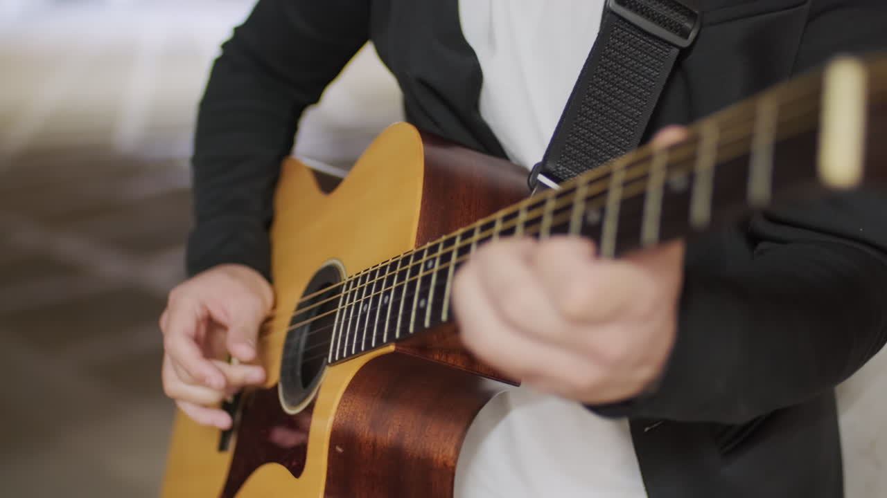 Close Up of Musician Playing Guitar in Underpass