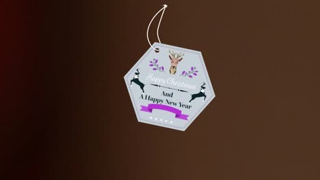 animation of christmas greetings on tag over dark background