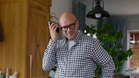 man talking on phone in kitchen