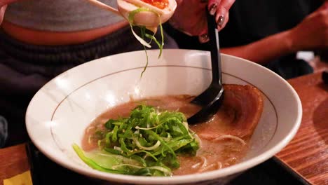 person preparing to eat ramen with chopsticks