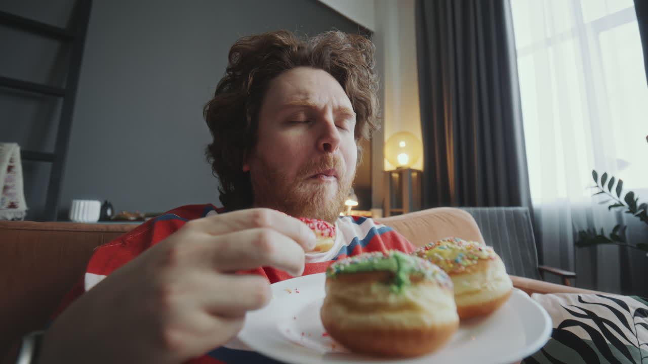 Man Eating Donuts at Home