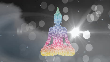 animation of colourful buddha statue over snow falling, clouds and bokeh lights