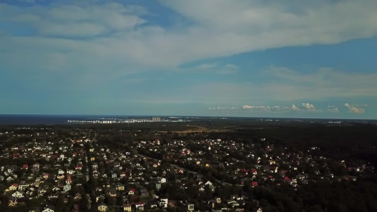 Aerial View of Suburban Area with Distant City and Tall Tower