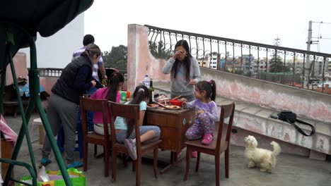 a family with their bichon maltese dog eating barbecue on the roof in the daytime in 4k