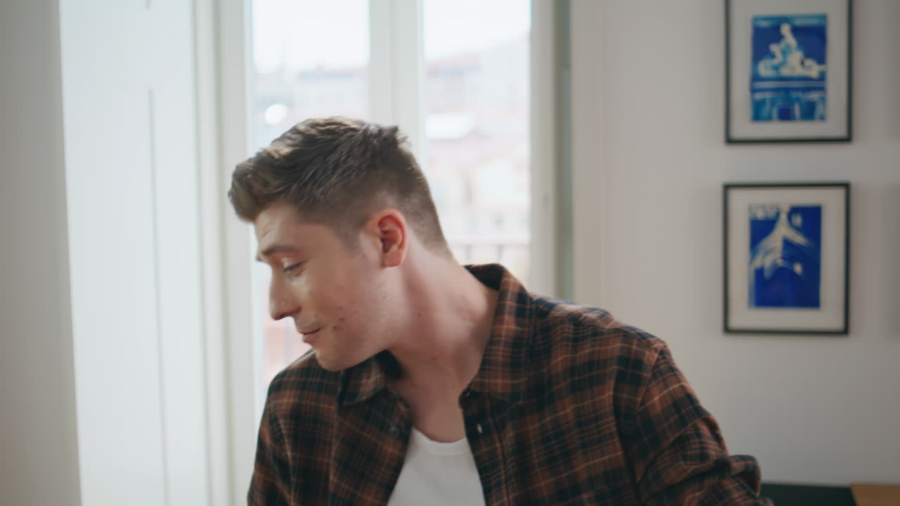 Joyful man catching food with mouth in kitchen closeup. Happy couple having fun