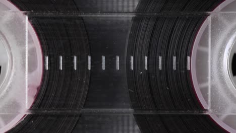 audio cassette reels tape in extreme close-up. vintage music cassette played in the player. close up.